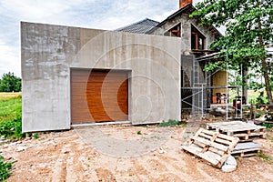 Brown automatic sectional metal garage doors of house.