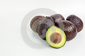 Brown avocado isolated with green half with seed white background