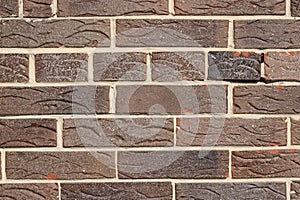 Brown background of unusual building brick