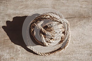 Brown ball of rope on old wooden background. Top view. Copy, empty space for text