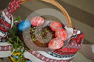 In the brown basket there is one Easter cake.