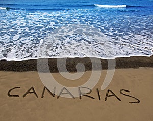 Brown beach sand with written word Canarias