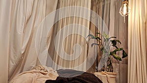 Brown Bean bag, big flower and white curtain window in living room. Background and location for photo shoot in studio