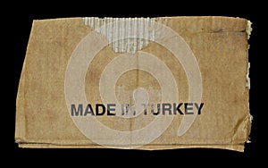 Brown and beige corrugated cardboard detail, made in Turkey, isolated on black background
