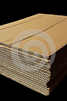 Brown and beige corrugated cardboard detail, isolated on black background