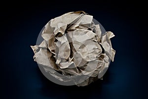 Brown and beige crumpled paper ball.