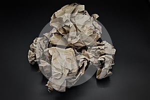 Brown and beige crumpled paper ball.
