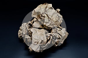 Brown and beige crumpled paper ball.