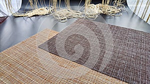 Brown and beige textured napkins, similar in weave to burlap on a black surface. Background, texture, frame and copy