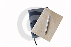 Brown and black notebook and pen