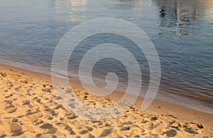 Brown and blue background, natural sand pattern and water closeup