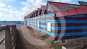 Brown and blue wooden booths on the beach