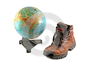 Brown boot next to a rotating globe