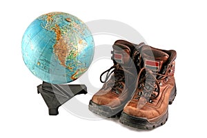 Brown boot next to a rotating globe