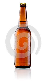 Brown bottle of beer with drops on white background