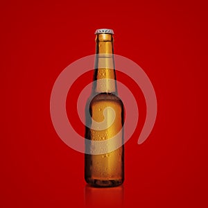 Brown bottle of fresh beer with drops of condensation on a red background