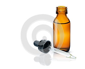 Brown bottle and glass dropper with black rubber cap with essential oil isolated on white