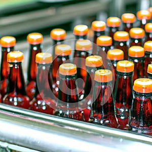 Brown bottles on conveyor belt in industrial factory. AI Image