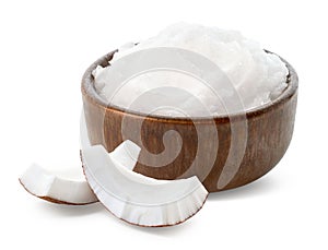 Brown bowl of coconut oil and fresh coconut pieces on white background