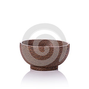 Brown bowl made from palm wood. Studio shot isolated on white