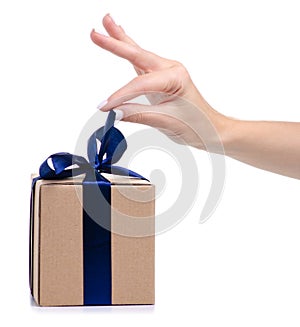 Brown box with blue ribbon bow gift in hand