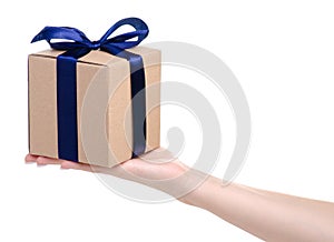 Brown box with blue ribbon bow gift in hand