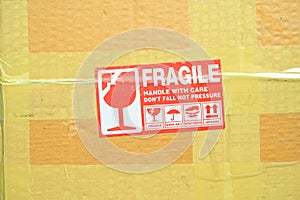 brown box packaging with warning fragile symbol