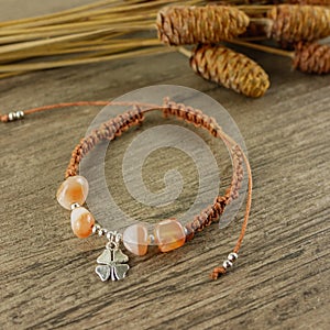 Brown bracelet on wooden background