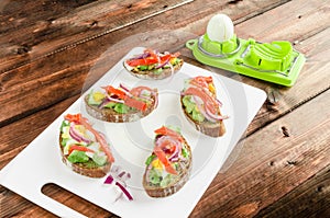 Brown bread with avocado, smoked salmon, boiled egg