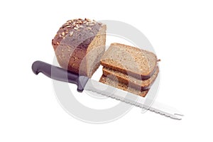 Brown bread with grain of sunflowers and kitchen knife