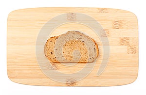 Brown bread slice on bamboo board