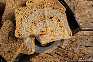 Brown bread slices on a wooden table