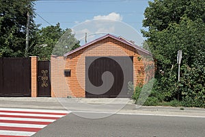 Brown brick garage with closed gates