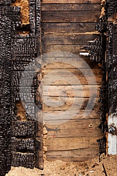 Brown burnt wall of house of wooden planks with embossed texture. background for copy space. concept of loss of real estate or