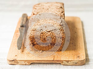 Brown butter pound cake with cinnamon on light concrete background. Top view, space for text.