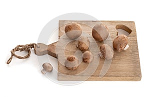 Brown button mushroom Agaricus brunnescens on a cutting board