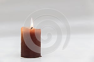 Brown Candle with Burning Flame