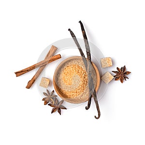 Brown cane granulated and cubes sugar in wooden bowl with spices