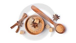 Brown cane granulated and cubes sugar in wooden bowl with spices