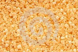 Brown cane sugar crystals close up. Food background