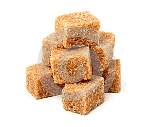 Brown cane sugar cubes isolated.
