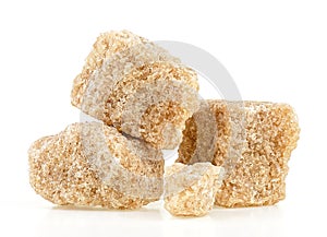 Brown cane sugar cubes isolated on white background. Unrefined demerara sugar pieces