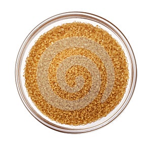 Brown cane sugar isolated on white background, top view