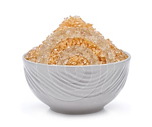 Brown cane sugar in the white bowl isolated on white