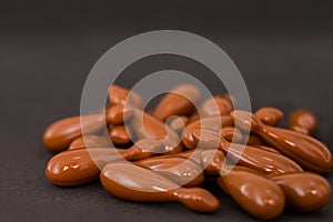 Brown capsules isolated on black background