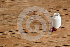 Brown capsules with a white plastic bottle