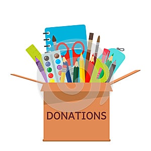 Brown cardboard box for donations full of stationery to a school for poor people