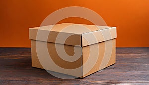 Brown cardboard box on orange background. Mock up. Packaging for delivery. Blank template