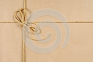 Brown paper or cardboard background with string