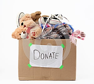 Brown cardboard box with a white sheet pasted and the inscription donate